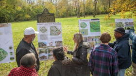 A group of students show their design proposals to community leaders.