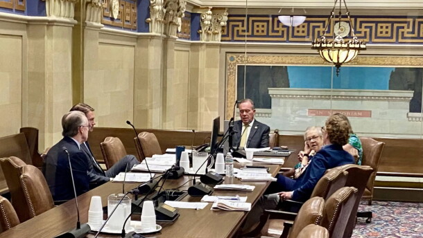 Oklahoma Treasurer Todd Russ, seen through a window, discusses options with attorneys during an executive session of the Tobacco Settlement Endowment Trust Board of Investors at the Capitol in Oklahoma City on Wednesday, July 1, 2026.