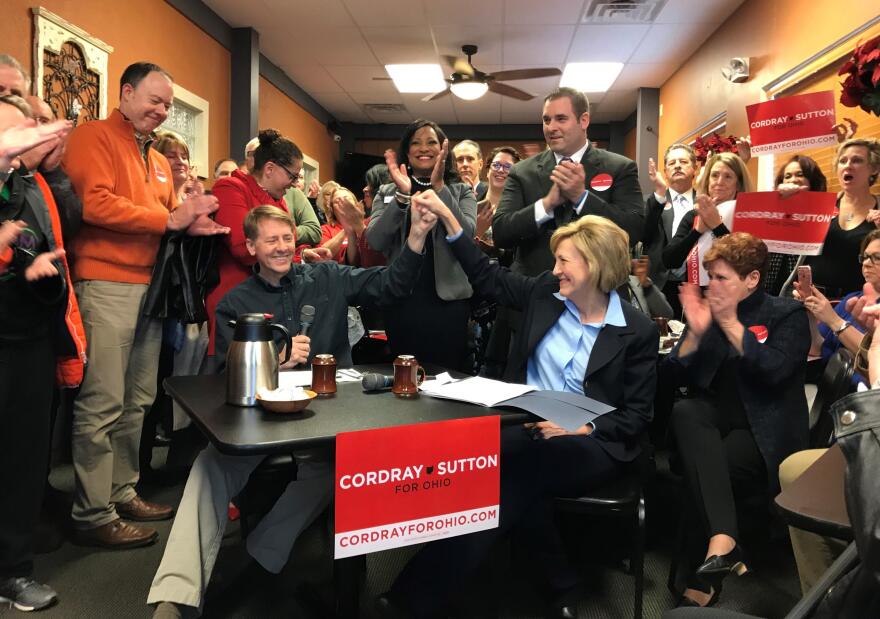 Richard Cordray, seated left, holds hands with new running mate Betty Sutton, right, during their campaign appearance Jan. 10, 2017 in an Akron restaurant.  (Photo: M.L. Schultze)