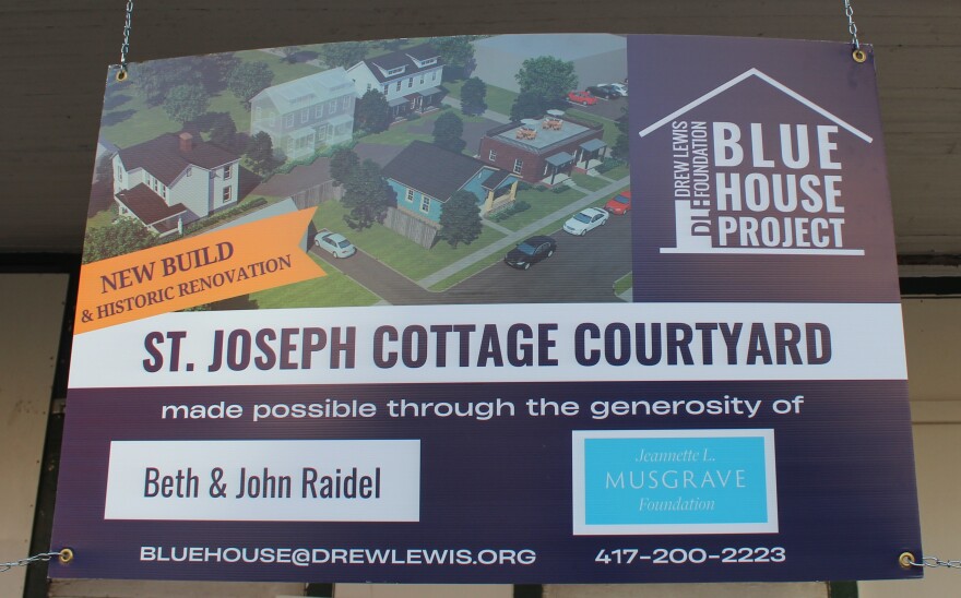 A sign that shows a rendering of the future St. Joseph Cottage Courtyard in Springfield, Mo. (photo taken November 14, 2025).