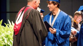 Matanzas High School Principal Jeff Reaves shakes a student's hand on graduation day. Reaves handwrote 459 notes to the graduating class of 2021 to celebrate their accomplishments.