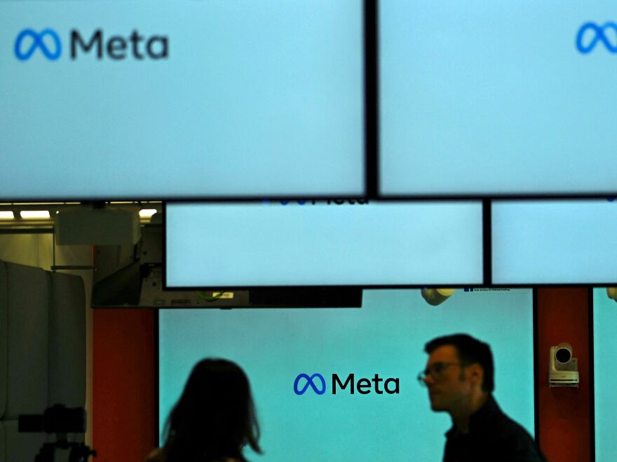 Visitors stand near screens displaying the Meta logo in Berlin on June 6. Under a U.S. judge's new ruling, much of the federal government is now barred from working with social media companies to address removing content that might contain "protected free speech."