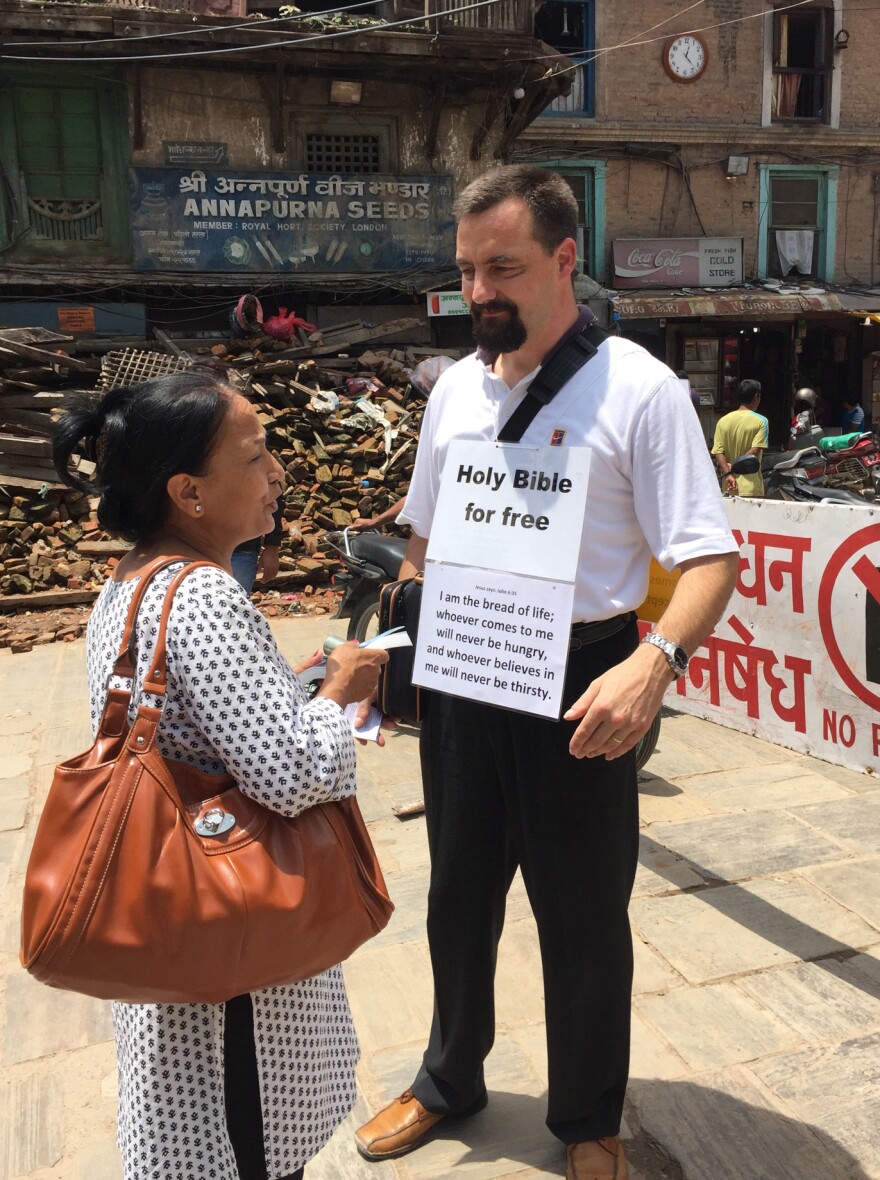 A Swiss missionary talks to a Nepali woman about the Bible in Kathmandu's old city.