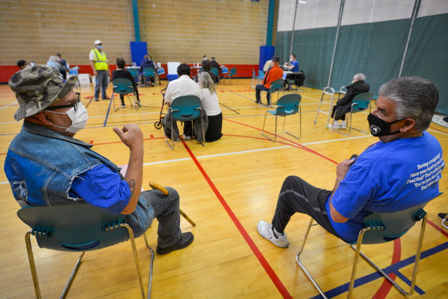 Anthony Guerra, 64, and John Garcia, 69, chat while waiting for their second dose of the Moderna vaccine at the Tony Aguirre Community Center on Monday. They were one of many west side Kansas Citians targeted by Truman Medical Centers to receive the vaccination in the Hispanic community.