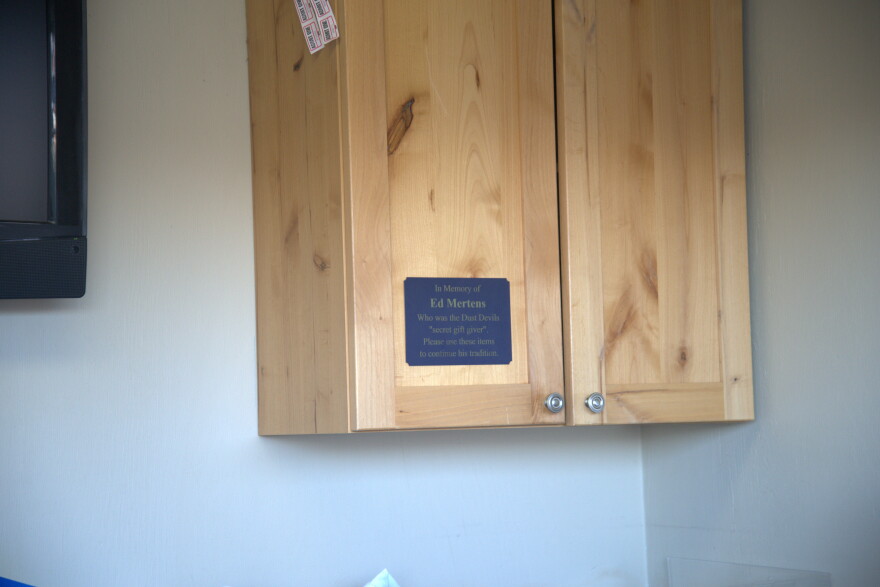 Picture of the Ed Mertens cabinet where gifts are stored for fans to take home.