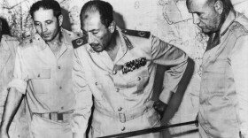 Egyptian President Anwar Sadat is flanked by senior military officers as he reviews maps of battlefield developments in the 1973 Arab-Israeli War. He's shown at army headquarters in Cairo on Oct. 15, 1973. Egypt and Syria attacked Israel, catching Israel and the CIA off-guard.