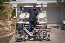 Kerry Simon stands with his bike in front of his four wheel drive truck. He says being a car enthusiast has made his moral dilemma over using gas all the more harder.