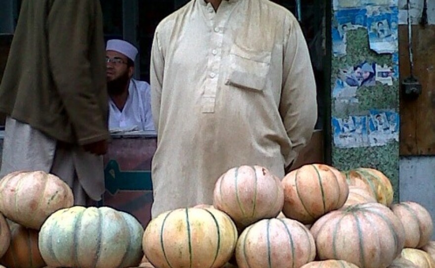 A vegetable vendor sells his summer offerings on the streets of Mingora. Nearly every storefront is now emblazoned with a green stenciled Pakistani flag. A year after the Taliban were driven out, fears of a slow economic recovery have replaced fears of the militants.