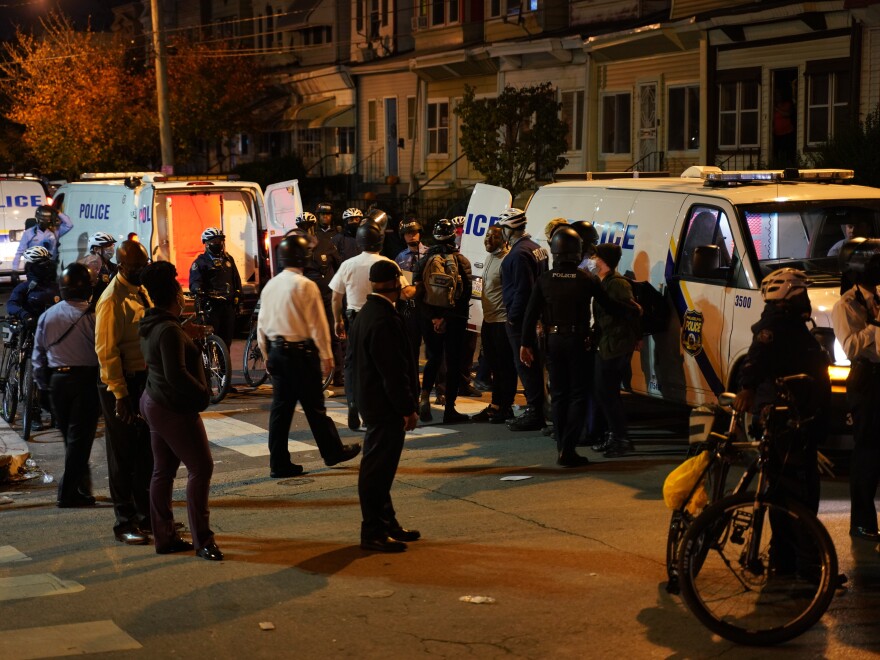 Philadelphia police issue a final warning for curfew violation to protesters at 55th and Pine Streets in West Philadelphia, on Wednesday, the third straight night of protesting and unrest after the fatal shooting of Walter Wallace Jr. by police.