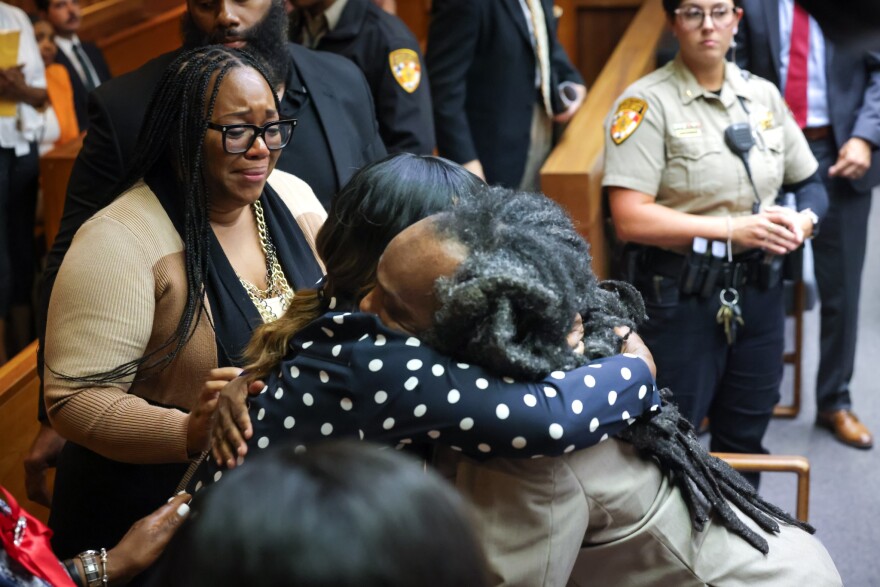 Benjamin Cole embraces his mother after a judge ordered authorities to release him from prison. His sister, Britney Pearson-Norfleet (left) watches emotionally.