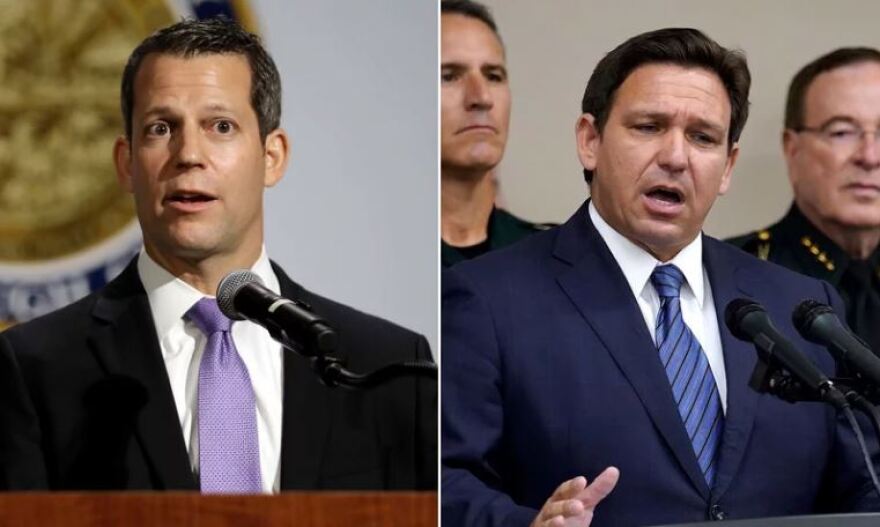 Florida Gov. Ron DeSantis, right, and Hillsborough County State Attorney Andrew Warren, left, in Tampa, Fla., after DeSantis suspended Warren. Warren vowed to fight his suspension over his promise not to enforce the state's 15-week abortion ban and support for gender transition treatments for minors.