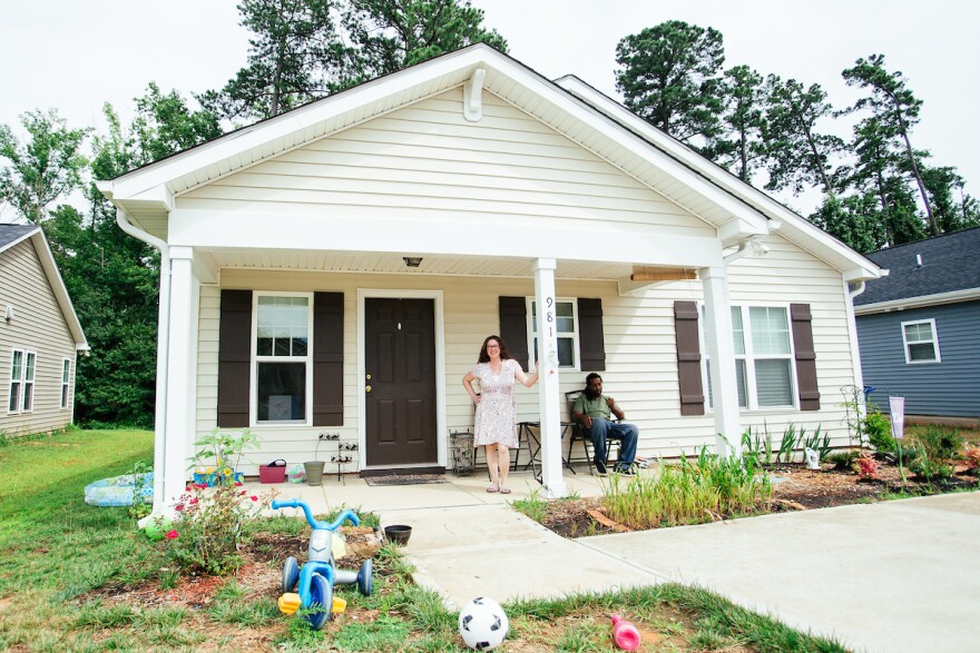 Jennifer and Warren Small in front of their house.