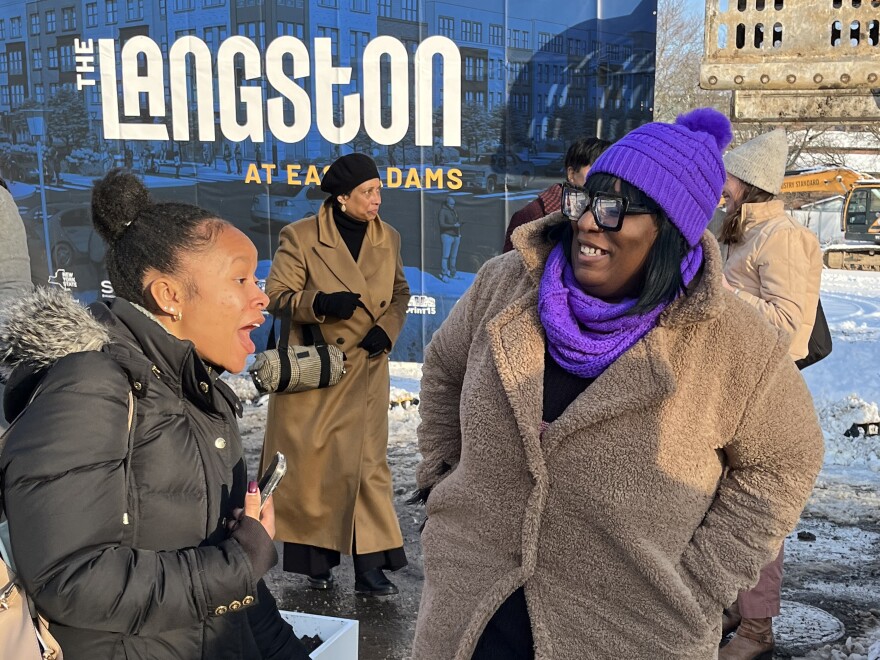 Former McKinney Manor resident Monique Hill, right, chats with a groundbreaking attendee, as Linda Littlejohn, center, passes by.