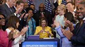 House Speaker Nancy Pelosi of Calif., surrounded by House Democrats, signs the Inflation Reduction Act of 2022 during a bill enrollment ceremony on Capitol Hill in Washington, Friday, Aug. 12, 2022.