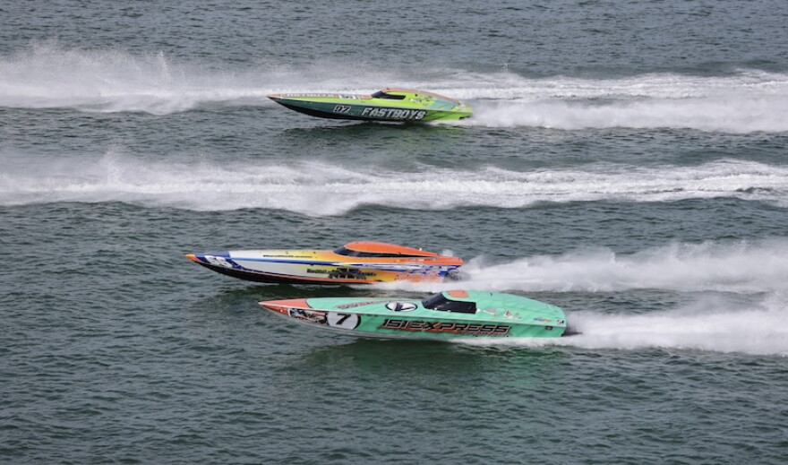Two boats race each other on the water 