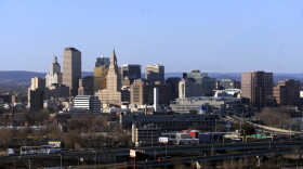 In this Feb. 7, 2010 aerial file photo, the skyline of Hartford, Conn., rises on the west bank of the Connecticut River. The struggling capital city is trying to persuade lawmakers to provide $40 million more in 2017 from the state's cash-strapped coffers to help offset a projected $65 million deficit in 2018. (Jessica Hill/AP)