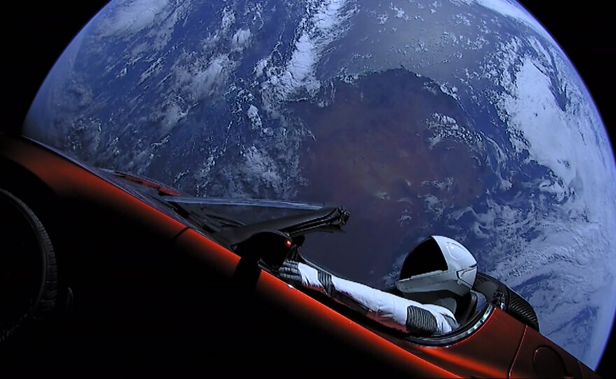 "Starman" in Elon Musk's Tesla Roadster with Earth in the background
