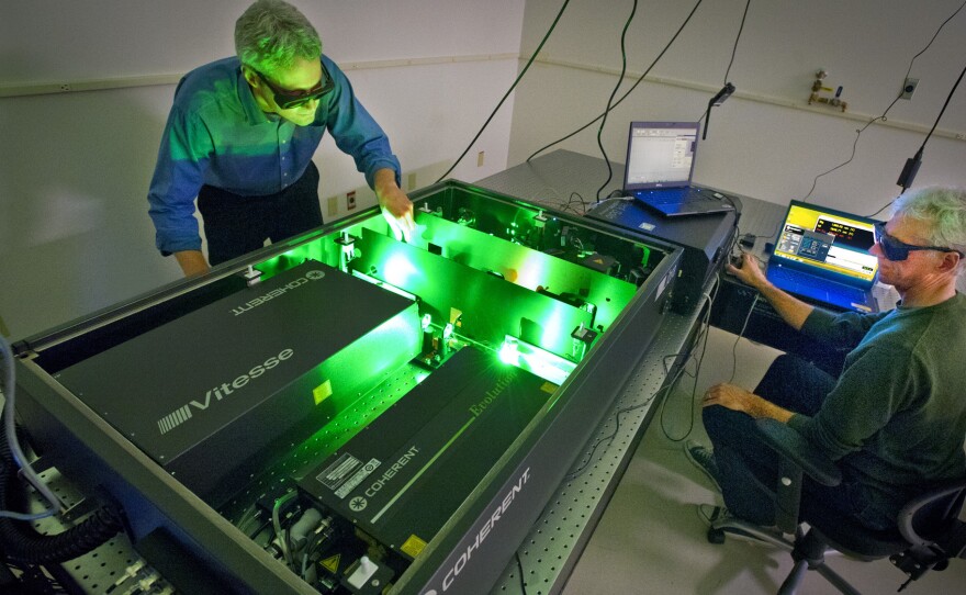 Ian Sharp (left) and Joel Ager use lasers to study the properties of water-splitting materials. The goal is to improve the efficiency with which solar energy can be used to create chemical fuel.