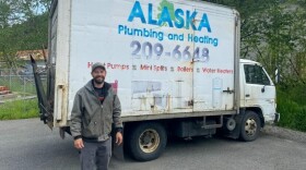 a person stands in front of a truck