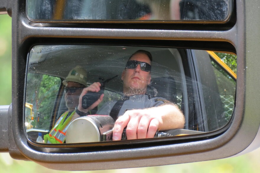 Pennsylvania State Police Cpl. Joe Holland aims a radar gun at traffic passing through a work zone on state Route 307 in Dunmore during a 2024 demonstration spotlighting enhanced traffic enforcement in construction zones. Speeding and distracted driving are key causes of work zone crashes, officials said. Full enforcement of the state's new distracted driving law takes effect today, June 5, 2026.