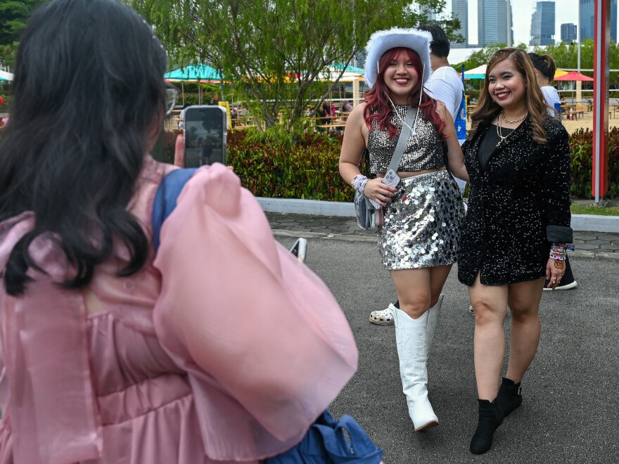 Taylor Swift fans, known as a Swifties, take photos as they arrive for the first of the pop star's six sold-out Eras Tour concerts at the National Stadium in Singapore on March 2.