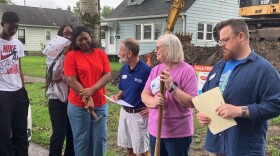Tom Fisher-King (center), CEO of Habitat for Humanity Quad Cities, looks to new homeowner Hugette during a ceremonial groundbreaking in East Moline, Aug. 15, 2026. Looking on are Zach Currier, Habitat family services coordinator, and Hugette's voilunteer mentor, Belinda Holbrook.