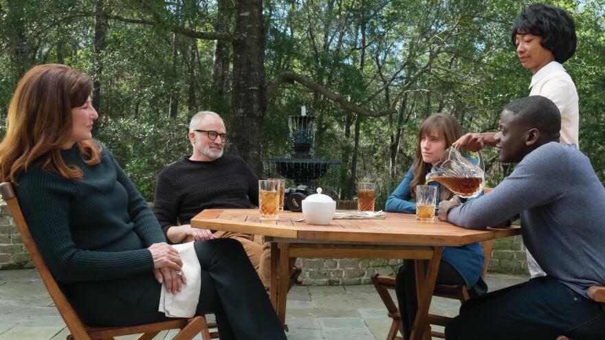 Chris sits down for tea with Rose's parents in <em>Get Out</em>. (From left, Catherine Keener, Bradley Whitford, Allison Williams, Betty Gabriel and Daniel Kaluuya).