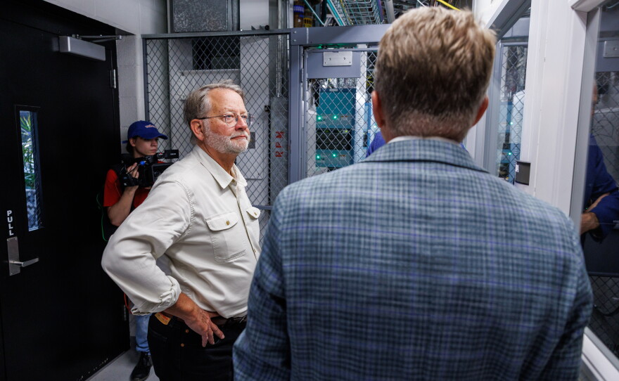 U.S. Sen. Gary Peters tours the Facility for Rare Isotope Beams in East Lansing, Mich., with Michigan State University President Kevin Guskiewicz and FRIB Laboratory Director Thomas Glasmacher on Aug. 28, 2026. The visit was the last stop on Peters' final motorcycle tour of Michigan as senator.