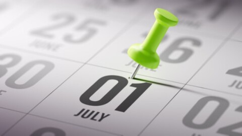 desk calendar with a tack going through july 1 