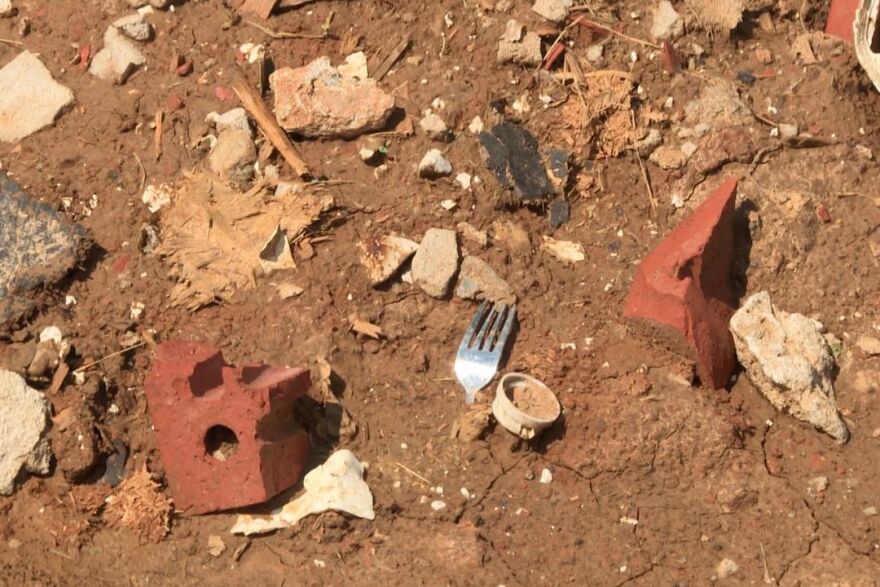 A fork of Carly Croft's is one of the few items left in the dirt where her home used to be.
