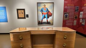 The “Icons in Ink’’ exhibition at the Maltz Museum includes the writing desk of Jerry Siegel, co-creator of Superman along with Joe Shuster, and a 1940s vintage Superman advertising painting.