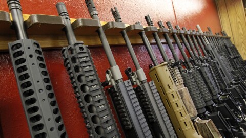 A row of rifles for sale is on display at a gun shop in Aurora, Colo., on July 20, 2012.