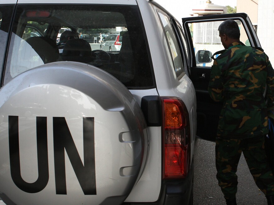 The United Nations observer team in Syria suspended its mission last Saturday, June 16, after facing repeated dangers and difficulties in trying to do its work. One observer is shown here next to a U.N. vehicle outside a hotel in Damascus.