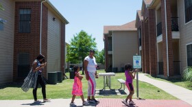 C'Artis Harris, walking with her children in 2017, was searching for housing that would accept her Section 8 voucher when NPR began following her in 2016. Today, Harris and her family still live in an area of high poverty.