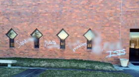Security video shows three people spray painting these vulgar anti-Muslim phrases on a wall of the Islamic Society of North America. WFYI has blurred the obscenities.