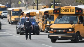  School buses line up on 127th Street and Black Bob Road following a shooting at Olathe East High School on Friday, March 4, 2022.
