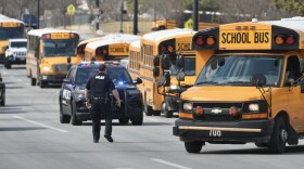  School buses line up on 127th Street and Black Bob Road following a shooting at Olathe East High School on Friday, March 4, 2022.