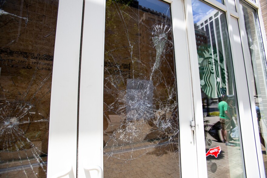 Windows are damaged at a Starbucks in downtown Raleigh, N.C. after a night of angry clashes between police and protestors left much of Downtown Raleigh damaged on Sunday, May 31, 2020.