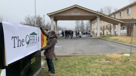 Pam Lott, Director of Administration for the non-profit Options for Helping Residents of Ashland, rolls up a banner covering the former Super 8 hotel in Ashland. It became the new home of a OHRA shelter starting in February.