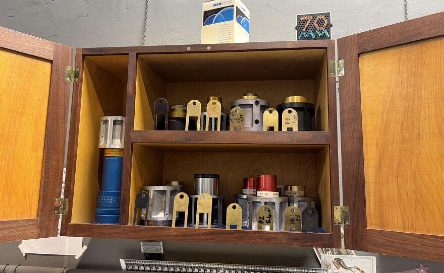 A cabinet in the tech booth holds film gates and lenses of various sizes at the ready to best project the different formats for reels of film.