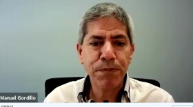 Dr. Manuel Gordillo wears white jacket in a Zoom call about surging coronavirus cases