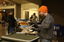 Man ladling soup into bowl.