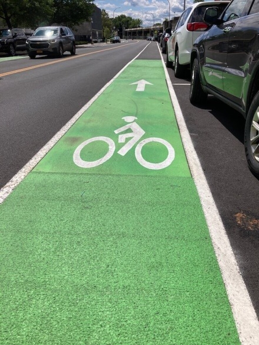 This is a protected bike lane on S. Clinton St. installed in summer 2023.