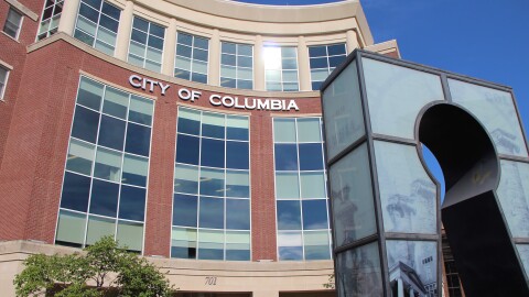 The exterior of the Columbia, MO city building and the key hole sculpture out front. 