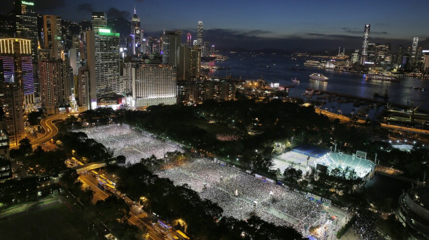 Tens of thousands of people attend a candlelight vigil at Victoria Park in Hong Kong on Wednesday to mark the 25th anniversary of the Chinese military crackdown on pro-democracy protests in Beijing.