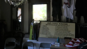 An old campaign sign — which Drew Williams believes is from the 1990s — sits among the racks of clothes inside the Marshall County Democratic Party headquarters.