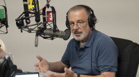 An image of a man sitting behind a microphone at KCUR