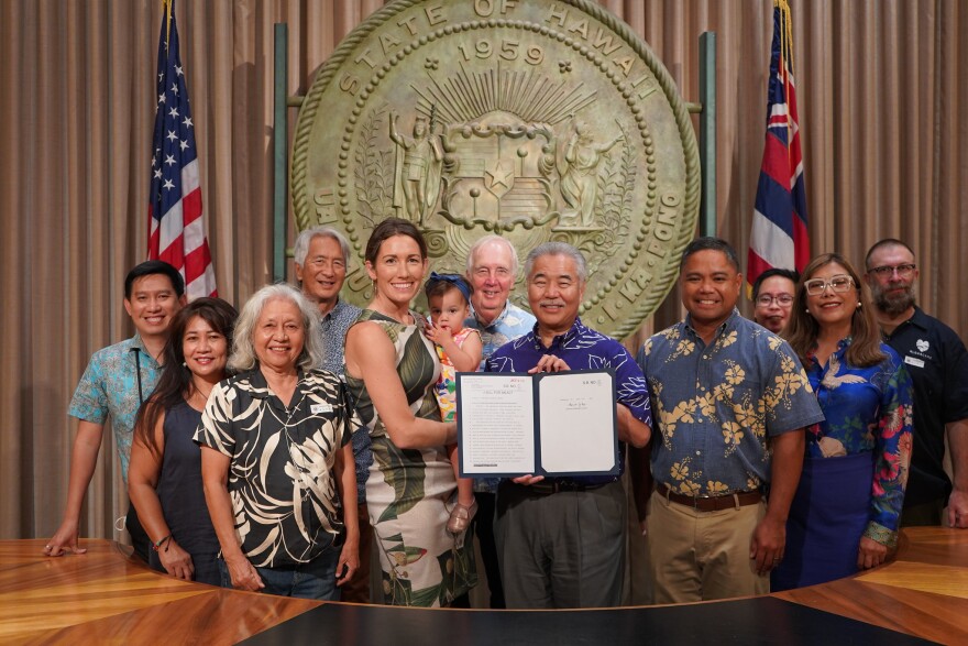 Gov. David Ige recently signed a bill into law that restores funding for immigrant resource centers. Pictured are legislators and community advocates who pushed for that bill, including Agnes Malate (second from left), Amy Agbayani (third from left) and Liza Ryan Gill (middle left).