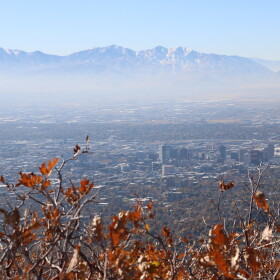 A view of the Salt Lake Valley with a visible layer of pollution in the air.