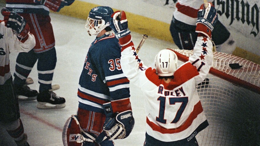 Washington Capitals center Mike Ridley celebrates his teammate Rod Langway's game-winning overtime goal against the New York Rangers in 1990. Later in the series, the Capitals would win again in overtime to take series and go to the Eastern Conference finals — and announcer Ron Weber was there for the famous call.